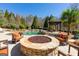 Beautiful pool with a stone-clad fire pit, comfortable seating, and a pergola for outdoor dining at 300 Annelise Park Dr, Fayetteville, GA 30214