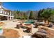 A luxurious pool area with a fire pit, lounge chairs, and a covered patio for relaxing at 300 Annelise Park Dr, Fayetteville, GA 30214