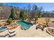 Resort-style pool with spa, waterfall feature, sun loungers, pergola, and fire pit, creating a backyard oasis at 300 Annelise Park Dr, Fayetteville, GA 30214