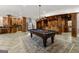 Recreation room with a pool table, bar with wooden cabinetry, and hardwood style flooring at 300 Annelise Park Dr, Fayetteville, GA 30214