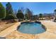 A backyard spa is surrounded by natural stone and professional landscaping at 300 Annelise Park Dr, Fayetteville, GA 30214