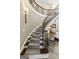 Close up of the curved staircase with gray patterned carpet and wrought iron railing at 300 Annelise Park Dr, Fayetteville, GA 30214
