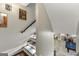 Carpeted staircase with art and wood railing, leading down to a recreation room with a pool table at 300 Annelise Park Dr, Fayetteville, GA 30214