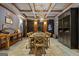 Elegant wine cellar featuring custom wine racks, wood floors, and a large dining table at 300 Annelise Park Dr, Fayetteville, GA 30214