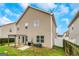 Spacious backyard featuring a covered patio, green grass, and a well-maintained wooden fence at 70 High Point Way, Hiram, GA 30141