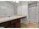 Well-lit bathroom with a single sink vanity and a shower featuring a white shower curtain at 70 High Point Way, Hiram, GA 30141