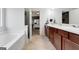 Bright bathroom featuring a large vanity with dual sinks and a separate tub at 70 High Point Way, Hiram, GA 30141