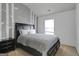 Comfortable bedroom featuring a black bed frame, soft grey bedding, and charming tree-themed wall art at 70 High Point Way, Hiram, GA 30141
