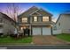 Charming two-story home featuring a two-car garage, stone accents, and well-manicured lawn at 70 High Point Way, Hiram, GA 30141