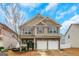 Charming two-story home with a stone facade, double garage, and well-manicured front yard at 70 High Point Way, Hiram, GA 30141