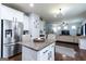 Modern kitchen with stainless steel appliances and granite countertops, seamlessly flowing into the living area at 70 High Point Way, Hiram, GA 30141