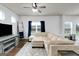 Spacious living room featuring a comfortable sectional sofa and ample natural light at 70 High Point Way, Hiram, GA 30141