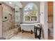 Luxurious bathroom with soaking tub, glass-enclosed shower, and stylish finishes at 135 Edgewater Trl, Fayetteville, GA 30215