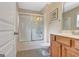 Bright bathroom with a tiled floor, shower and vanity with solid surface counter top at 135 Edgewater Trl, Fayetteville, GA 30215