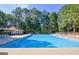 Community pool featuring a bath house and multiple lounge chairs at 135 Edgewater Trl, Fayetteville, GA 30215
