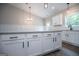 A kitchen island with white cabinets, light countertops, and dark hardware at 3264 Greenhill Ct, Villa Rica, GA 30180