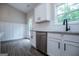 Bright kitchen featuring white cabinets, stainless steel appliances, and light countertops at 3264 Greenhill Ct, Villa Rica, GA 30180