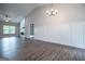 Open concept living room with hardwood floors and decorative board and batten accent wall at 3264 Greenhill Ct, Villa Rica, GA 30180