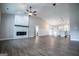 A well lit open-concept living room area with a decorative fireplace and seamless kitchen access at 3264 Greenhill Ct, Villa Rica, GA 30180