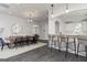 Well-lit open concept dining room and bar area with modern accents and fixtures at 928 Hesston Dr, Locust Grove, GA 30248