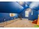 Attic area with blue walls and ceiling, carpeted floor, and exercise equipment at 10 Allen Oaks Way, Covington, GA 30016