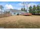 Backyard view featuring a wooden deck, well-maintained lawn, and a wood fence at 10 Allen Oaks Way, Covington, GA 30016