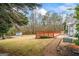 Expansive backyard featuring a wooden deck and a matching shed, perfect for outdoor entertaining at 10 Allen Oaks Way, Covington, GA 30016