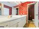 Main bathroom showing double sink vanity, decorative wallpaper, and separate toilet at 10 Allen Oaks Way, Covington, GA 30016