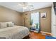 Cozy bedroom features hardwood floors, a ceiling fan, and natural light from the window at 10 Allen Oaks Way, Covington, GA 30016