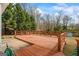 View of the spacious wooden deck, great for gatherings, with a glimpse of the cozy backyard shed at 10 Allen Oaks Way, Covington, GA 30016