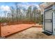 Outdoor wooden deck, ideal for relaxing, with an adjacent entryway featuring a secure storm door at 10 Allen Oaks Way, Covington, GA 30016