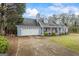 Traditional-style home featuring a two-car garage, dormer windows, and a covered front porch with a vibrant red door at 10 Allen Oaks Way, Covington, GA 30016