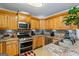 Well-equipped kitchen with stainless steel appliances, granite countertops, and stylish tile backsplash at 10 Allen Oaks Way, Covington, GA 30016