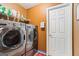 Laundry room featuring side-by-side washer and dryer with cabinets for storage at 10 Allen Oaks Way, Covington, GA 30016