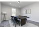 Formal dining room with modern black chairs, dark wood table, gray walls and a view from the window at 1041 Claas Way, Locust Grove, GA 30248