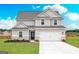 Inviting two-story home featuring a neutral palette, attached two-car garage, and a well-manicured lawn at 1041 Claas Way, Locust Grove, GA 30248