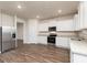 Well-lit kitchen features stainless steel refrigerator and appliances, granite countertops, and white cabinets at 1041 Claas Way, Locust Grove, GA 30248