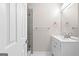 A clean half-bathroom featuring a white vanity, updated fixtures and a shower at 135 Weeping Willow Way, Tyrone, GA 30290