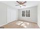 Bedroom with wood-look floors, ceiling fan, and a sunny window at 135 Weeping Willow Way, Tyrone, GA 30290