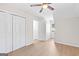 A light-filled bedroom featuring wood-look flooring, neutral walls, a closet and a single window at 135 Weeping Willow Way, Tyrone, GA 30290