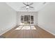 Bedroom featuring wood-look floors, a ceiling fan and a large window at 135 Weeping Willow Way, Tyrone, GA 30290