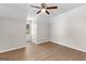 A light-filled bedroom featuring wood-look flooring, neutral walls, and a single window at 135 Weeping Willow Way, Tyrone, GA 30290