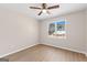 Light filled bedroom with wood-look floors and a large window at 135 Weeping Willow Way, Tyrone, GA 30290