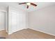 A bright bedroom featuring wood-look flooring, neutral walls, and a ceiling fan for added comfort at 135 Weeping Willow Way, Tyrone, GA 30290