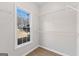 Walk-in closet features wire shelving and a window bringing in natural light at 135 Weeping Willow Way, Tyrone, GA 30290