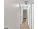 Hallway with wood-look floors leading to bedrooms and bathrooms at 135 Weeping Willow Way, Tyrone, GA 30290