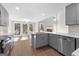 A kitchen featuring gray cabinets, stainless steel appliances, and a view to the outdoor living space at 135 Weeping Willow Way, Tyrone, GA 30290