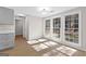 A kitchen with gray cabinets and a view of the backyard through a set of large windows at 135 Weeping Willow Way, Tyrone, GA 30290