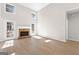 Bright living room with wood-look flooring and a stone fireplace at 135 Weeping Willow Way, Tyrone, GA 30290