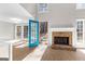 Bright living room featuring a stone fireplace, hardwood floors, and an open doorway to the outdoors at 135 Weeping Willow Way, Tyrone, GA 30290